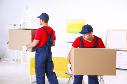 Movers loading boxes and furniture in Paddington street setting