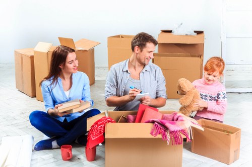 Packed moving boxes and furniture in a Paddington flat