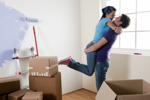 Mover using safe lifting techniques during a job