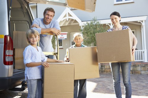 Local removals van loading household items in central London